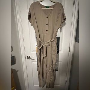 Large tan jumpsuit. Button down the front with a tie in the front